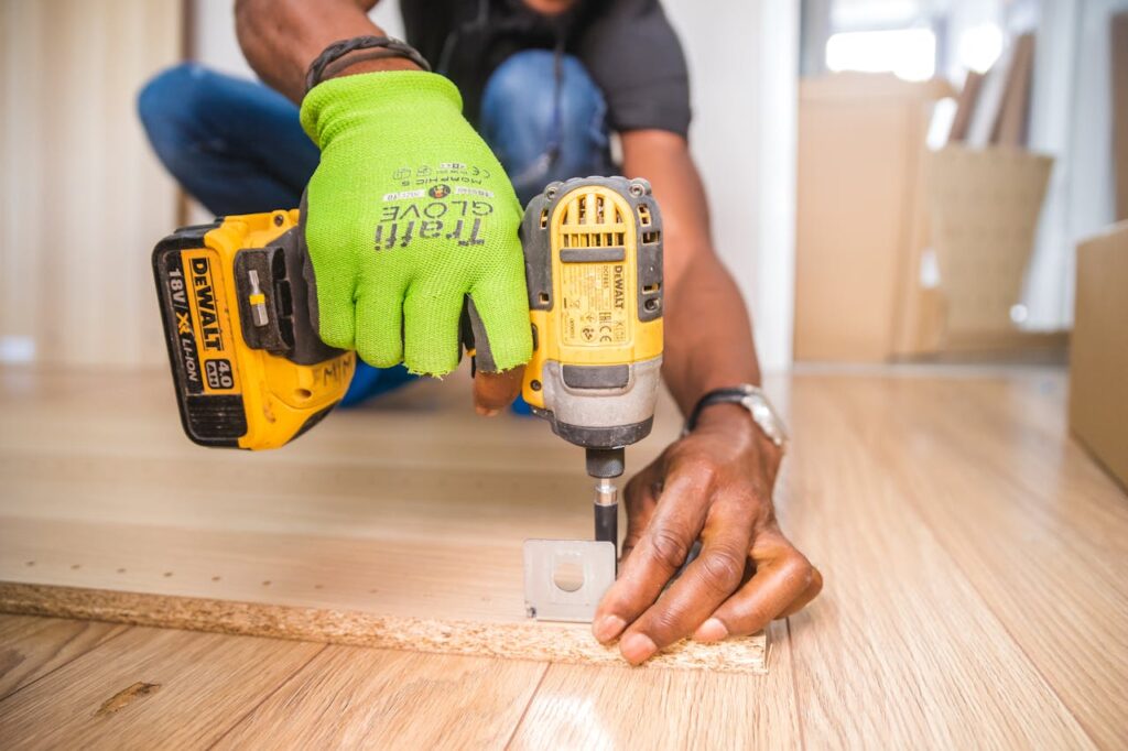 Mastering the First Impression: Your intriguing post title goes here Man using a power drill for home improvement on a wooden floor with precision.